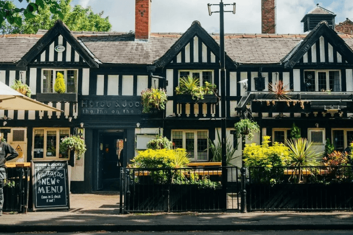 Chorlton-cum-Hardy offers a relaxed vibe with cosy pubs and trendy bars, perfect for enjoying live sport with a friendly crowd.
